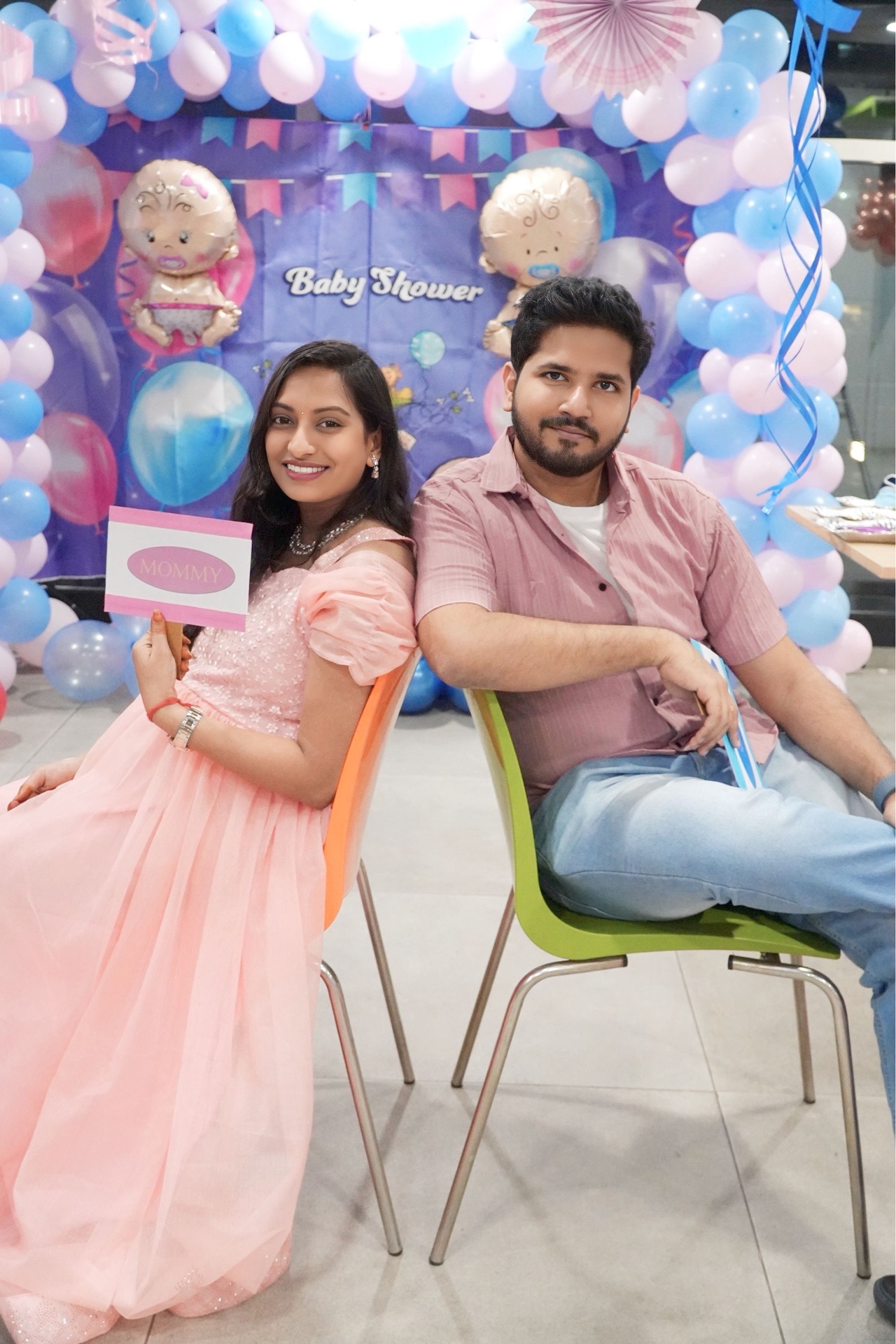 Parents-to-be seated together at their baby shower