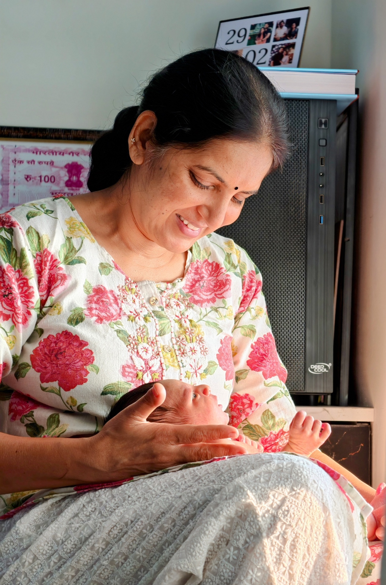 Grandmother holding her grandson for the first time in the morning sun