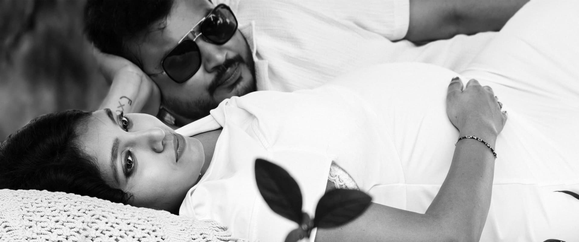 Black and white portrait of a couple lying together
